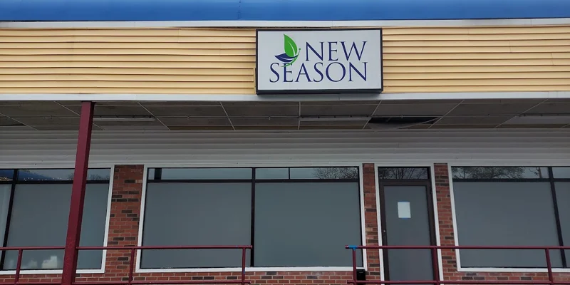 Outside the facility entrance with large glass windows and signage.