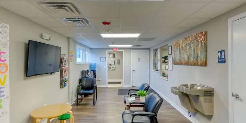 Lobby with chairs and reception desk.