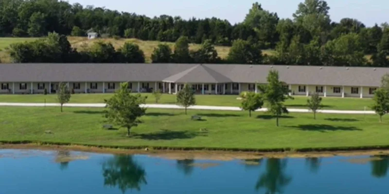 A scenic view of a lake surrounded by lush greenery and trees.