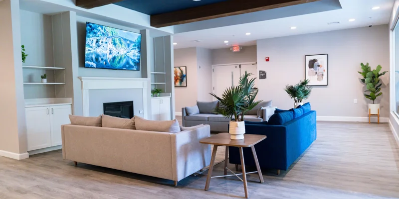 Lounge area featuring sofas, tables, and TV.