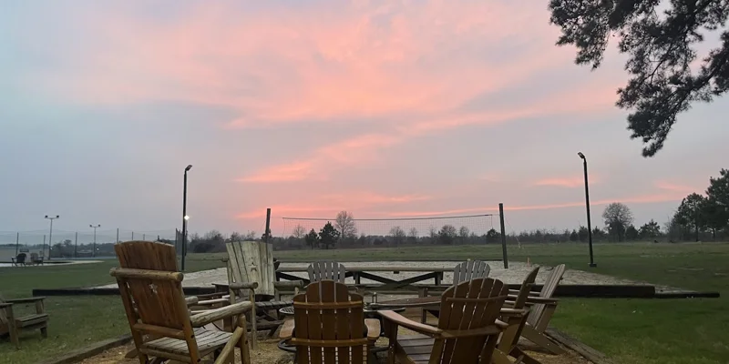 Outdoor chairs with a fire pit under.