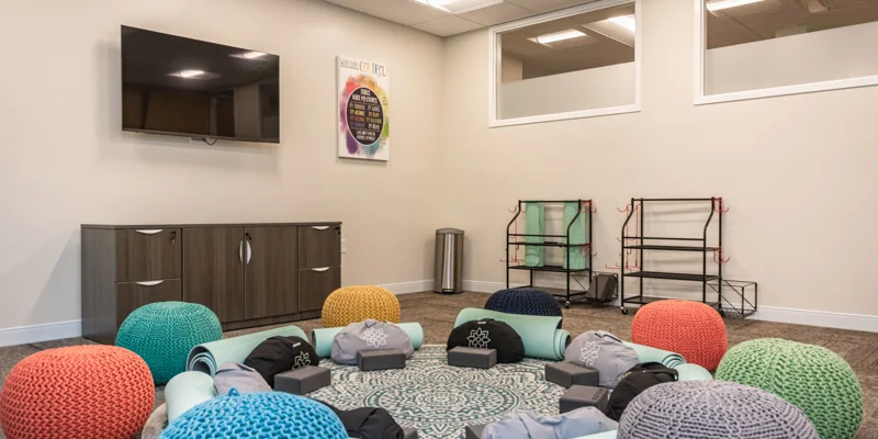 Yoga room with cushions and mats.