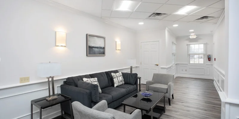 Waiting area with a couch and armchairs.