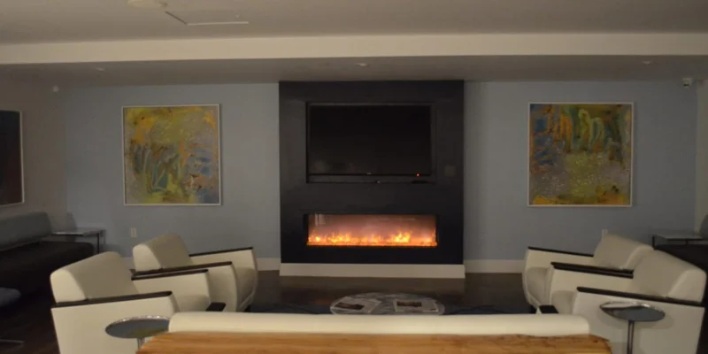 Lounge with a fireplace, TV, and modern seating.