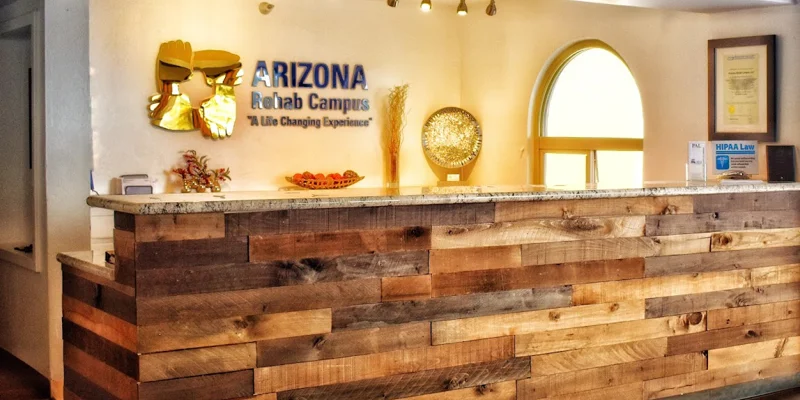 Rehab center reception desk with rustic wood and signage.