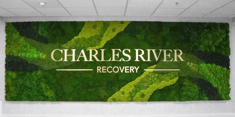Green wall with signage "Charles River Recovery".