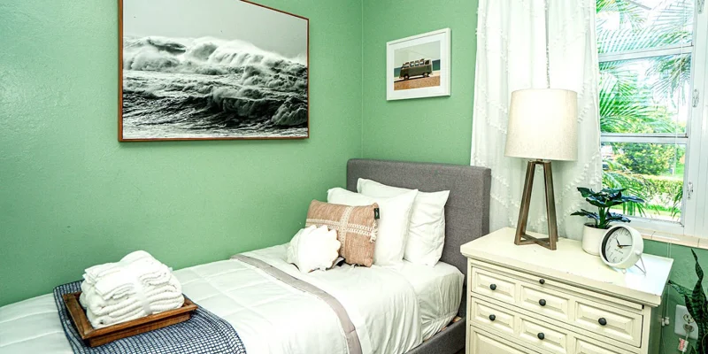 Bedroom with a single bed, dresser, and a window.