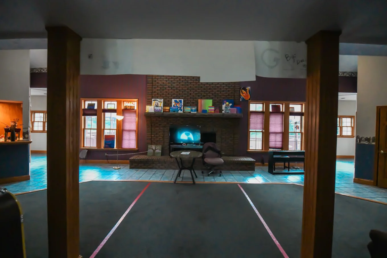 Cozy common area with a brick fireplace, seating, and decor.