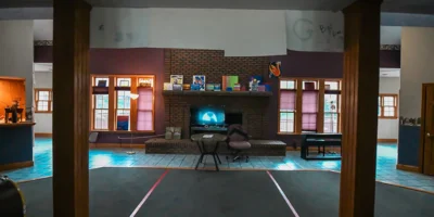 Cozy common area with a brick fireplace, seating, and decor.