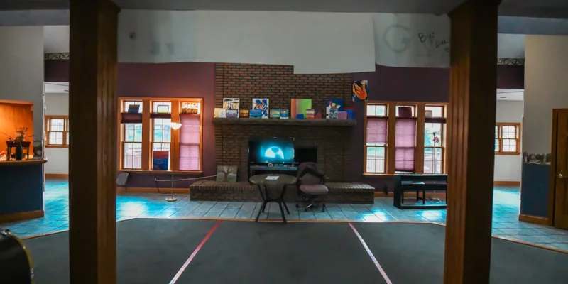 Cozy common area with a brick fireplace, seating, and decor.