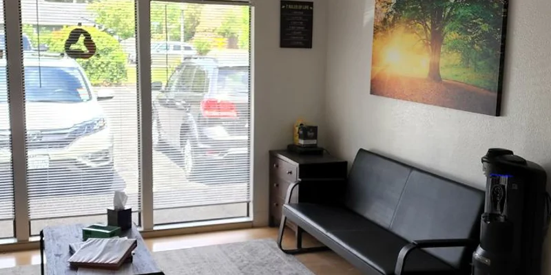 Waiting area with seating and table.