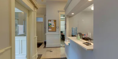 Hallway with reception desk and bulletin board.