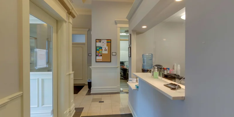 Hallway with reception desk and bulletin board.