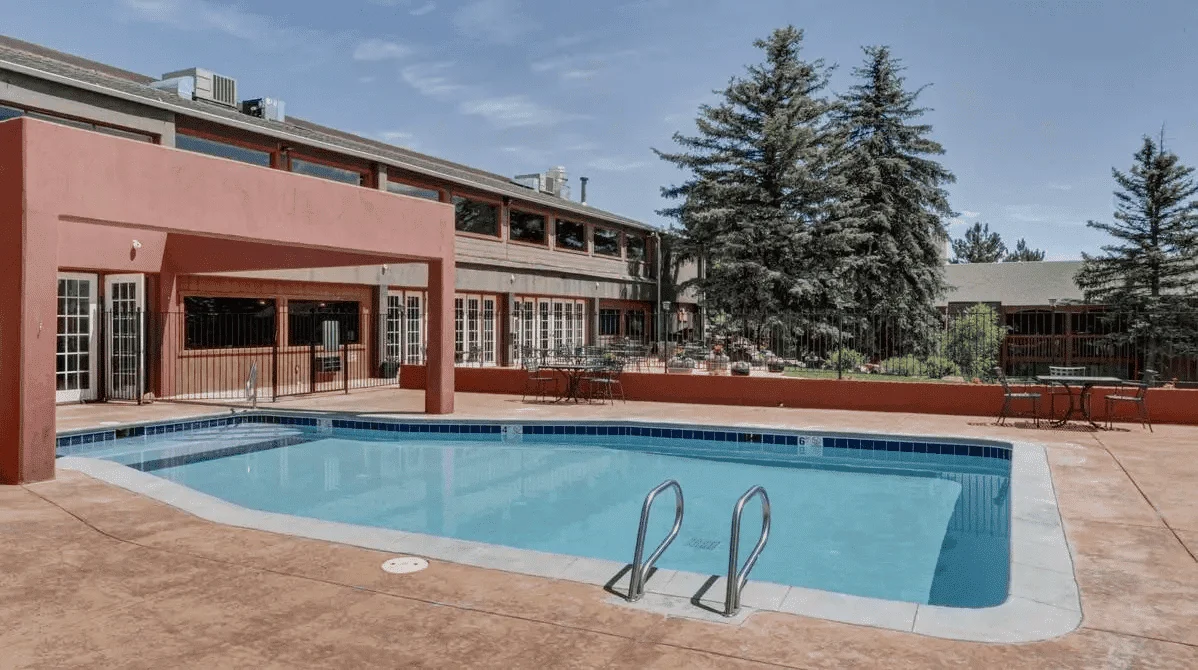 Pool area with patio and seating.