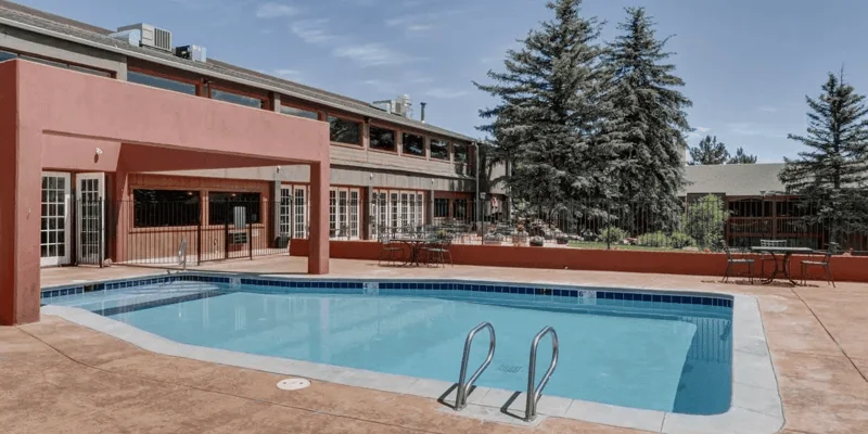 Pool area with patio and seating.