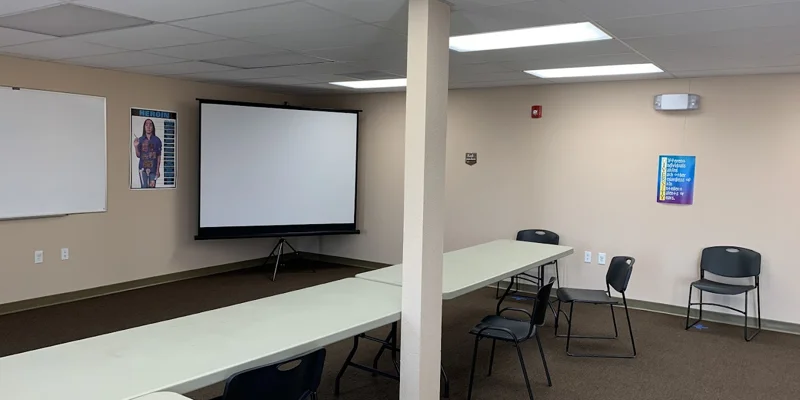 Classroom with whiteboard and projector.