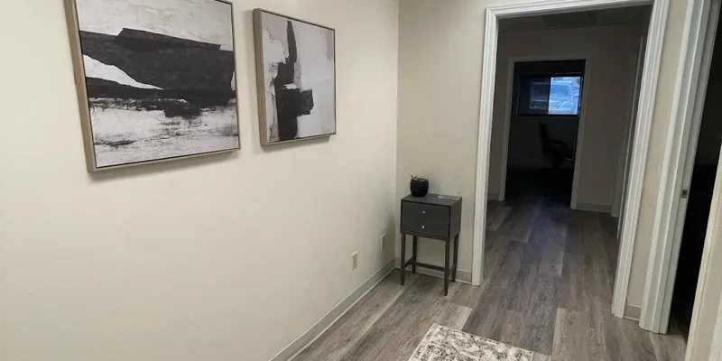 Hallway with rugs, decor, and multiple doorways