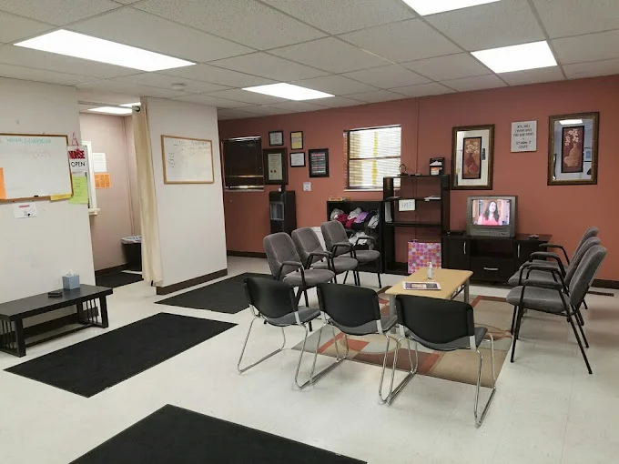 Waiting area with seating and a TV.