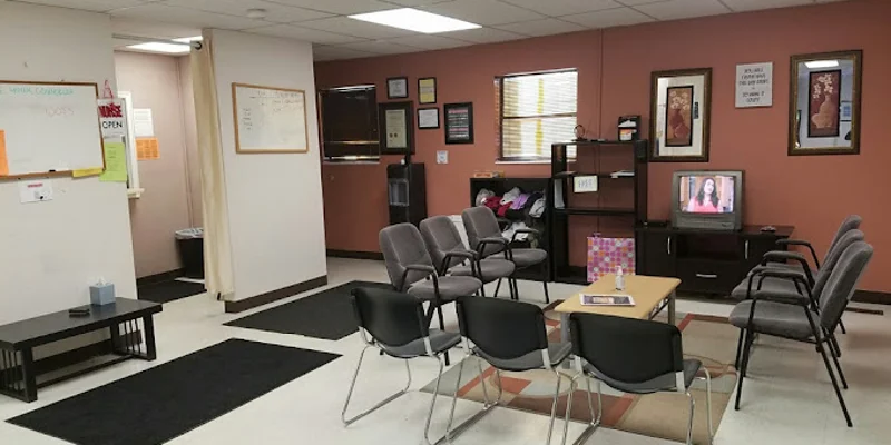 Waiting area with seating and a TV.