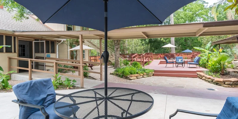 Patio area with seating under large umbrellas.