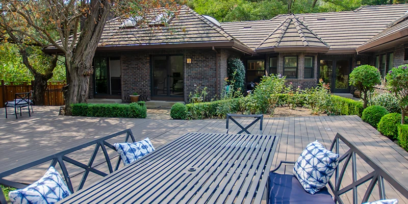Outdoor patio with seating and a table.