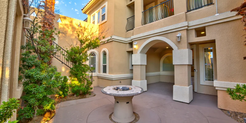 Courtyard with arched entrances and a fire pit.