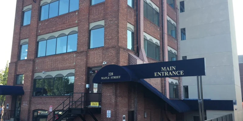 Exterior with a blue awning over main entrance.