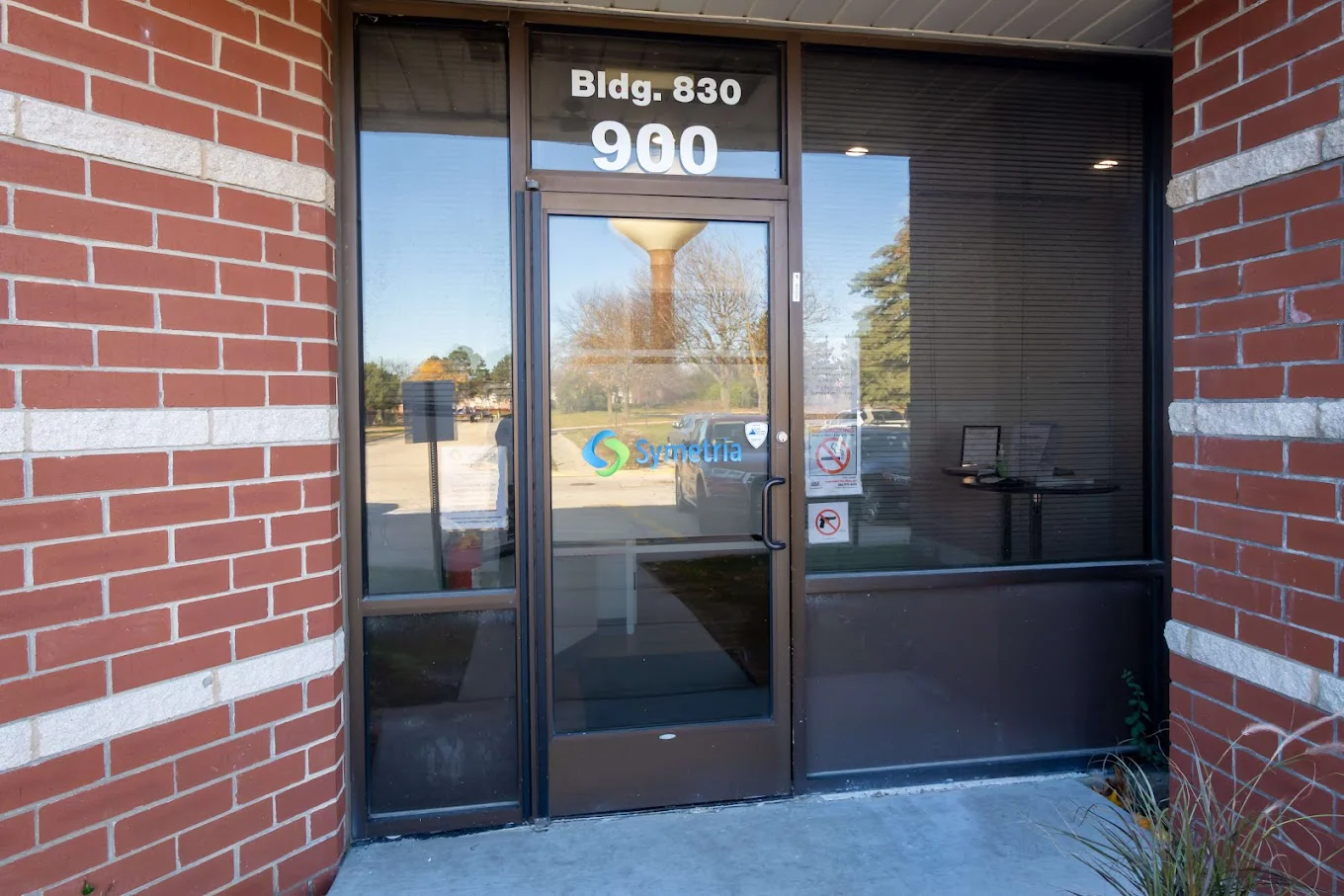 Entrance of a modern center with glass doors and front sign.