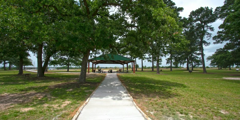 Outdoor pathway leading to a shaded pavilion.