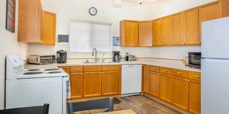 Kitchen with wooden cabinets, a stove, and appliances
