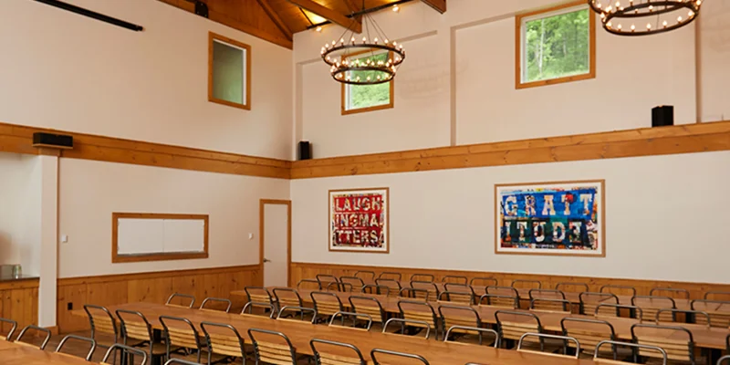 Dining hall with tables and chairs.