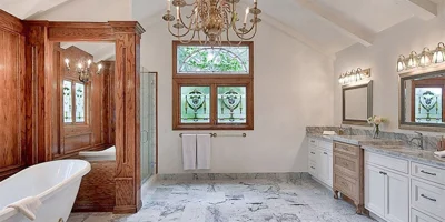 Bathroom with a clawfoot tub, and double vanities.