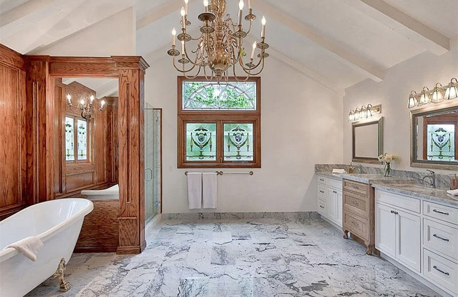 Bathroom with a clawfoot tub, and double vanities.