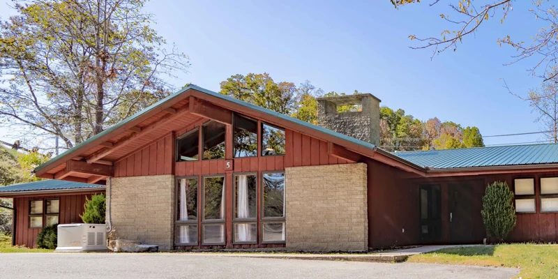 A single-story rehab facility with a green roof and large windows