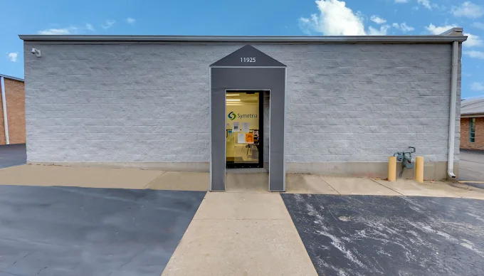 Entrance with glass doors and a visible clinic logo above.