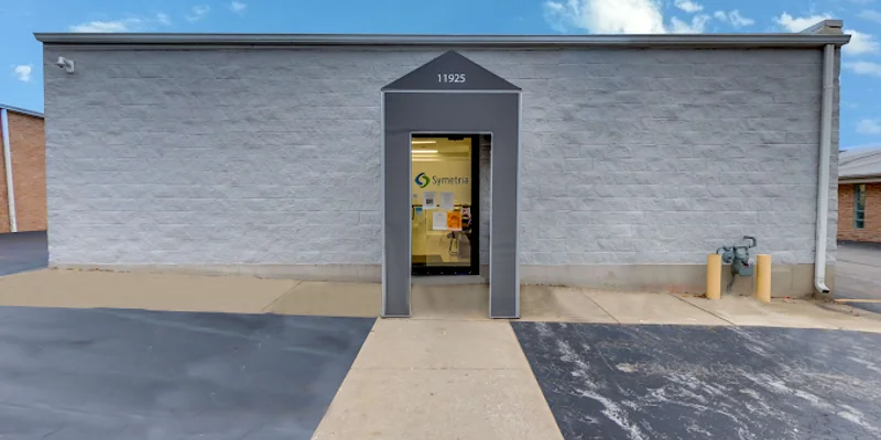 Entrance with glass doors and a visible clinic logo above.
