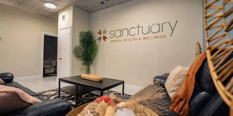 Cozy lobby with dark sofas and decorative wall signage