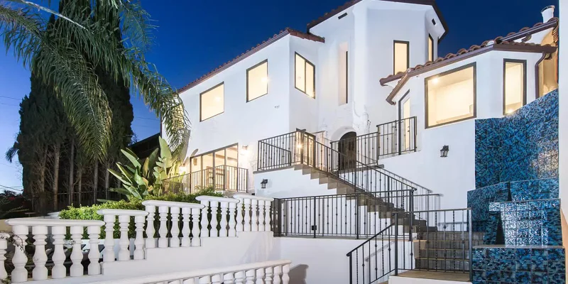 Exterior view of rehab facility with stairs and white facade