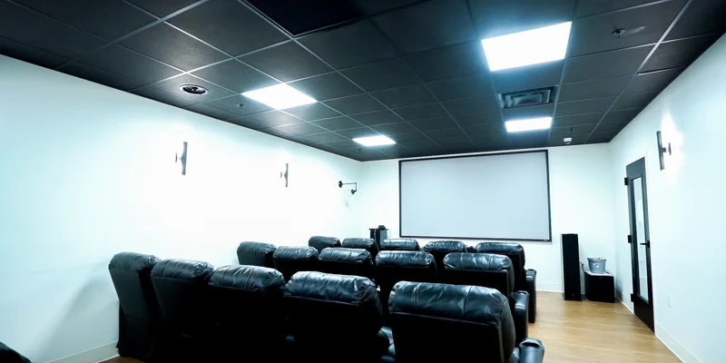 Small theater with leather recliners and screen