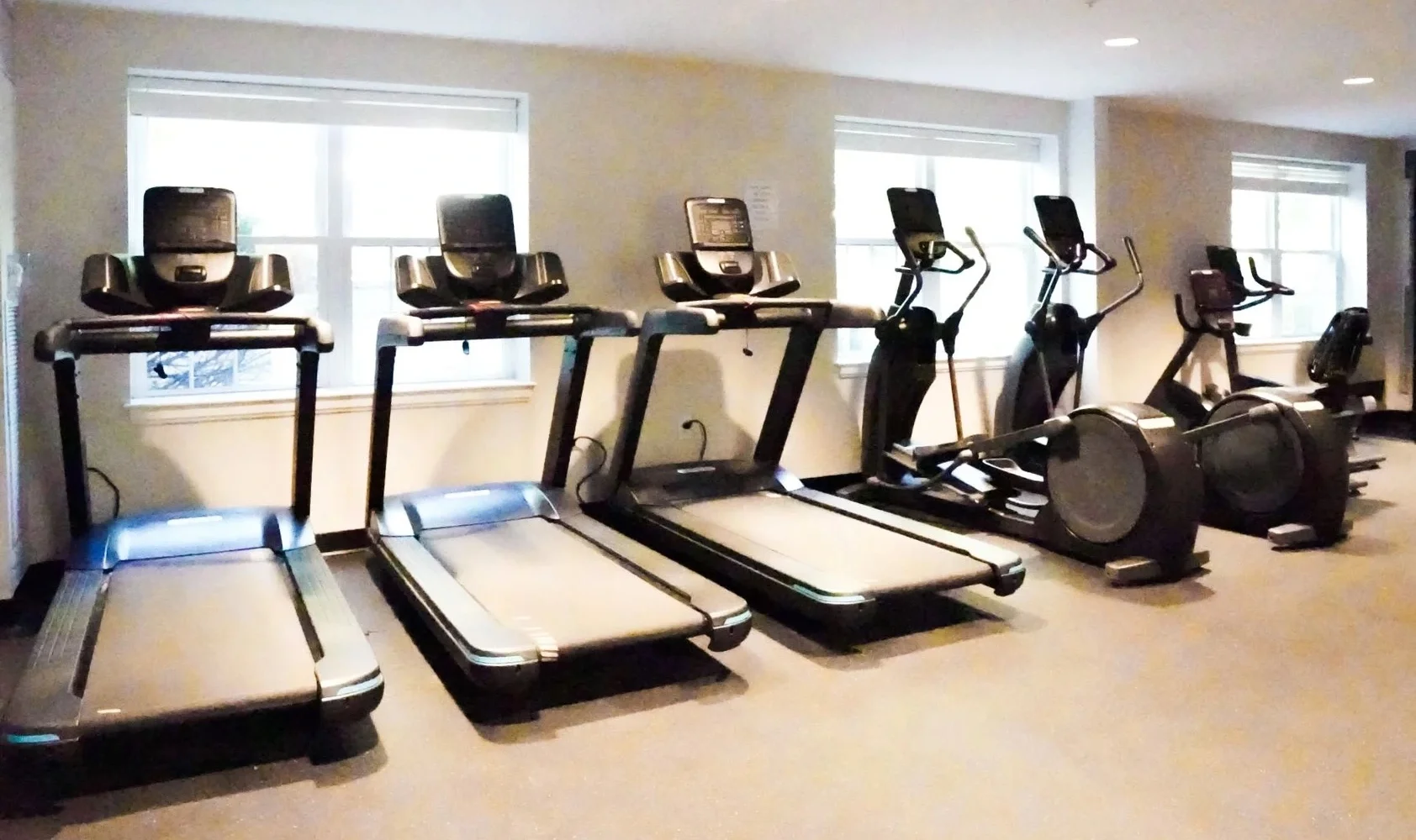 Gym with treadmills and elliptical machines.