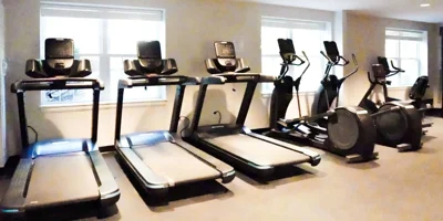 Gym with treadmills and elliptical machines.