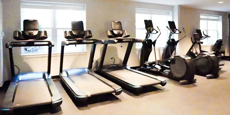 Gym with treadmills and elliptical machines.