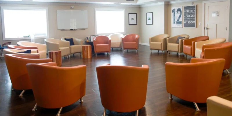 Group therapy room with a circular arrangement of chairs.