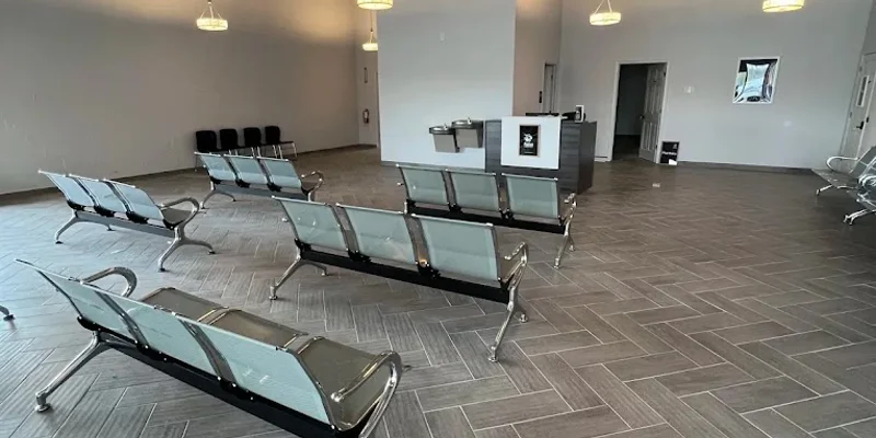 A spacious waiting area with modern seating and high ceilings.