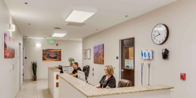 Reception area with staff behind tables.
