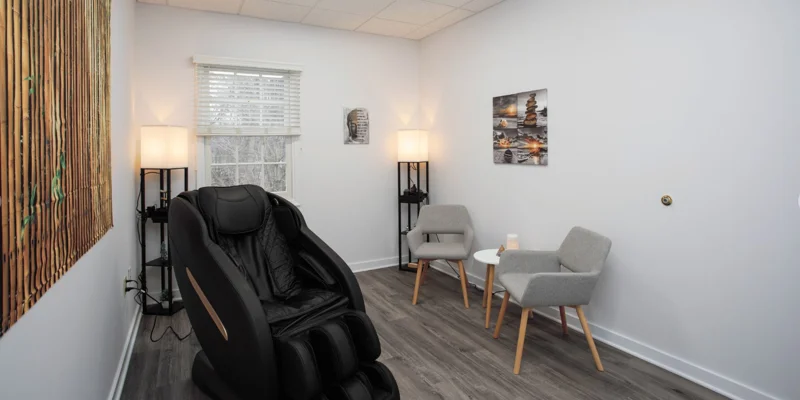 Therapy room with massage chair and decor.