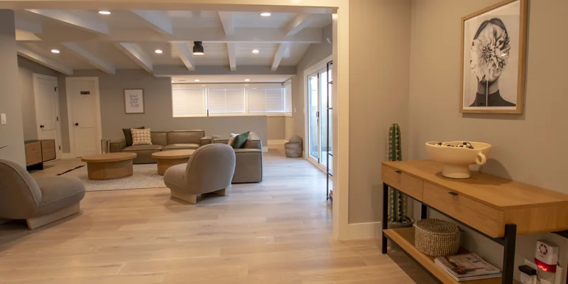 Modern lounge with a sectional sofa, round tables, and soft lighting