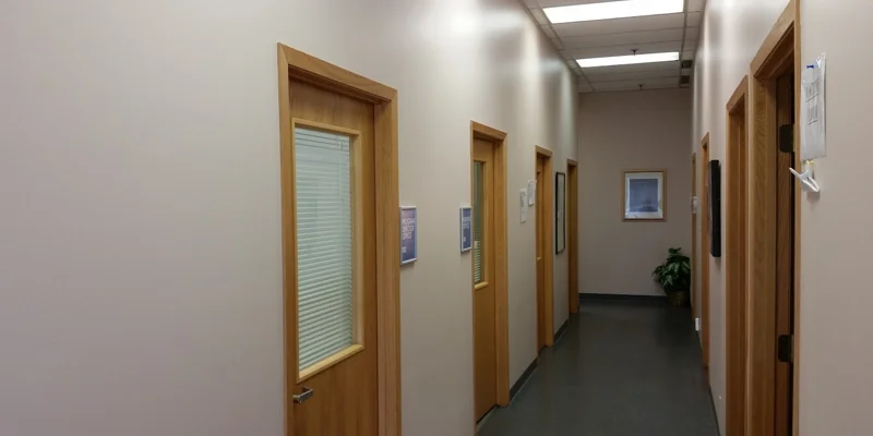 Hallway with wooden doors and offices.