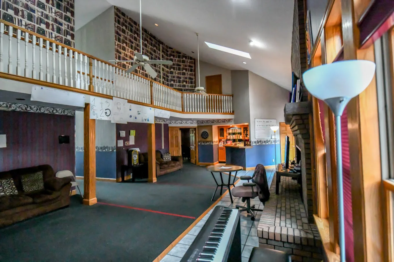 Spacious rehab facility lounge with a loft, seating, and decor.