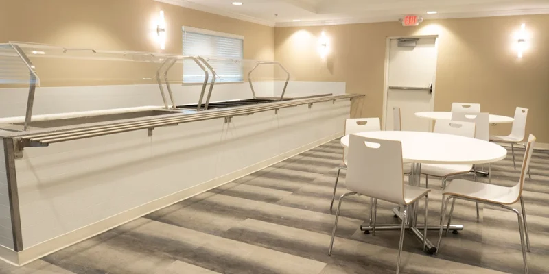 Dining area featuring a tables, chairs, and a servers station.